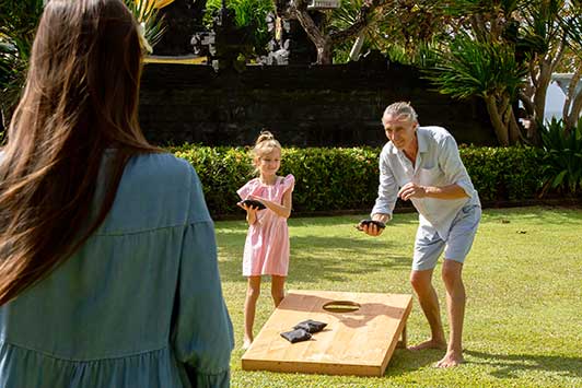 people playing cornhole